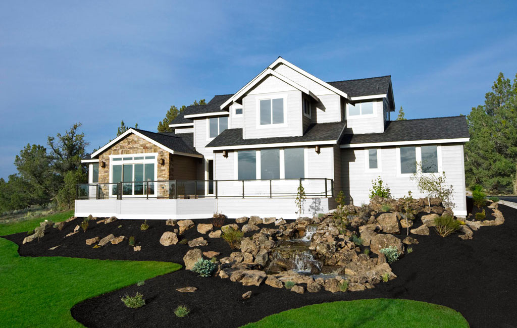 A White Brick House with Red Mulch